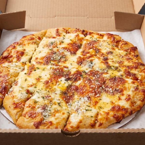 Cheesy garlic bread, cut into slices, in a brown cardboard pizza box.